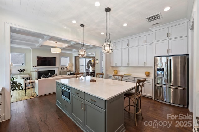 2630 Mary Butler Way, Charlotte, NC 28226 - kitchen with appliances with stainless steel finishes, white cabinetry, a kitchen bar, dark wood-style flooring, and recessed lighting