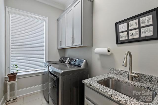 2630 Mary Butler Way, Charlotte, NC 28226 - laundry area featuring washing machine and clothes dryer, cabinet space, baseboards, ornamental molding, and light tile patterned floors