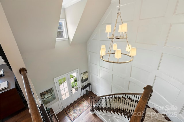 2630 Mary Butler Way, Charlotte, NC 28226 - staircase featuring a chandelier, a decorative wall, wood finished floors, healthy amount of natural light, and a towering ceiling