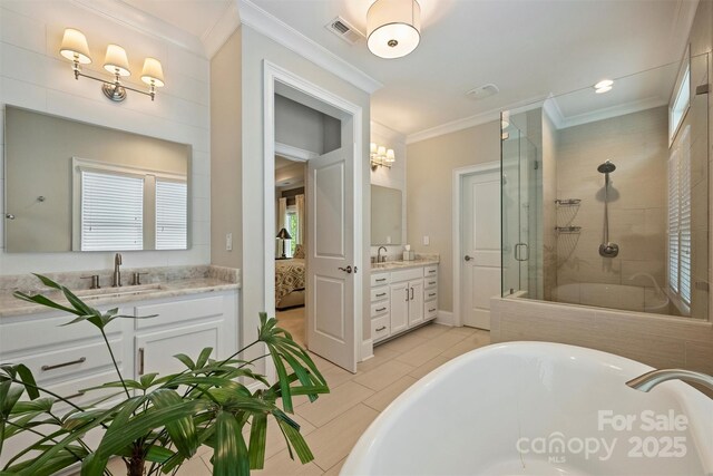 2630 Mary Butler Way, Charlotte, NC 28226 - full bathroom with a stall shower, a soaking tub, crown molding, two vanities, and tile patterned floors