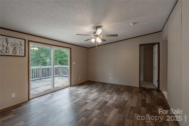 spare room featuring wood finished floors, a ceiling fan, ornamental molding, a textured ceiling, and a smoke detector