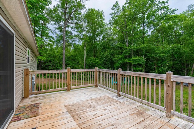 wooden deck featuring view of wooded area
