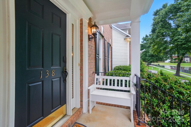 138 Montibello Dr, Mooresville, NC 28117 - view of exterior entry featuring a porch and brick siding