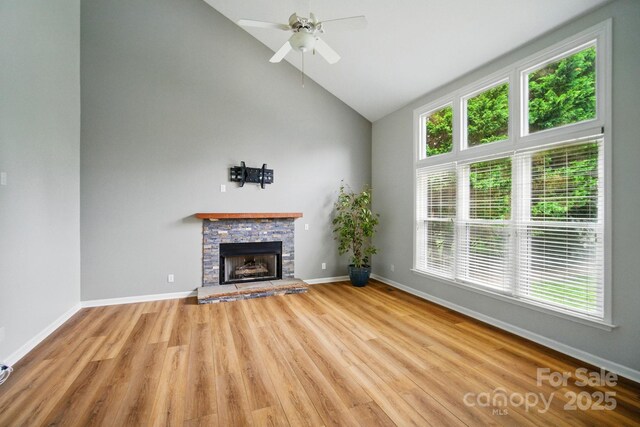 138 Montibello Dr, Mooresville, NC 28117 - unfurnished living room with wood finished floors, a fireplace, high vaulted ceiling, ceiling fan, and baseboards