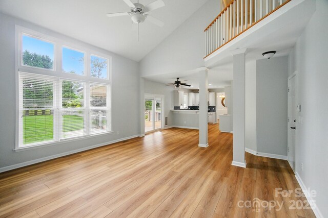 138 Montibello Dr, Mooresville, NC 28117 - unfurnished living room with a ceiling fan, light wood finished floors, high vaulted ceiling, and baseboards