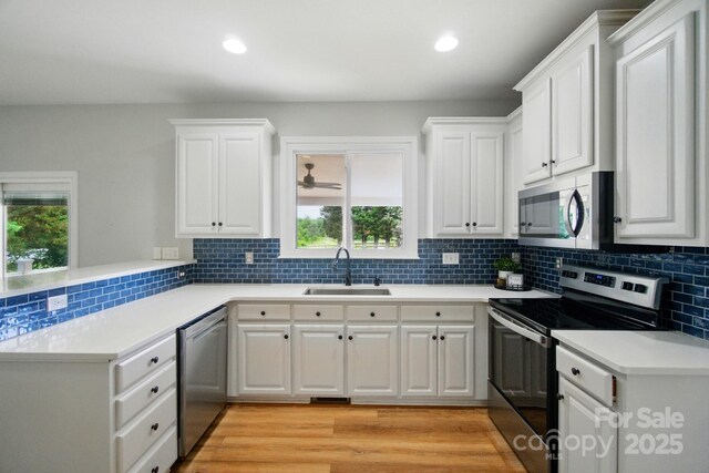 138 Montibello Dr, Mooresville, NC 28117 - kitchen with stainless steel appliances, a sink, a peninsula, healthy amount of natural light, and recessed lighting