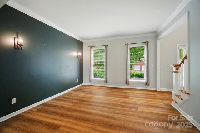 138 Montibello Dr, Mooresville, NC 28117 - empty room with stairs, light wood-style floors, crown molding, and baseboards