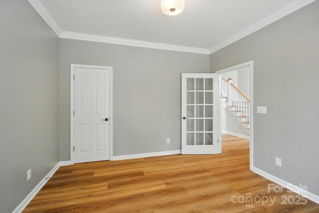 138 Montibello Dr, Mooresville, NC 28117 - empty room featuring ornamental molding, light wood finished floors, stairs, and baseboards