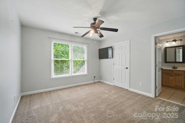 138 Montibello Dr, Mooresville, NC 28117 - unfurnished bedroom featuring light carpet, baseboards, connected bathroom, a sink, and a ceiling fan