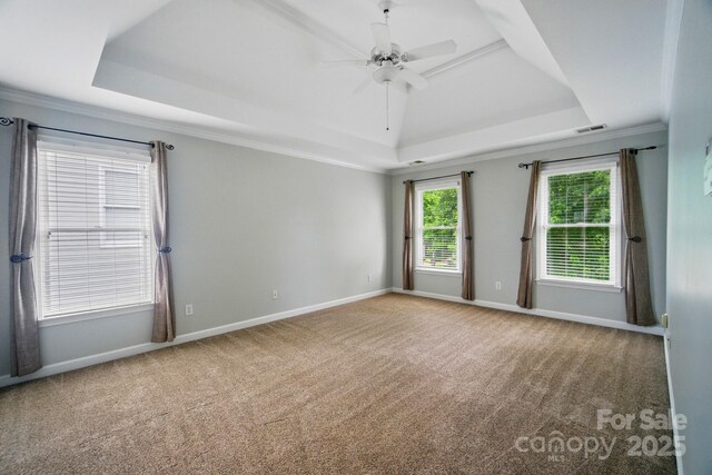 138 Montibello Dr, Mooresville, NC 28117 - spare room featuring a raised ceiling, carpet flooring, ceiling fan, baseboards, and crown molding