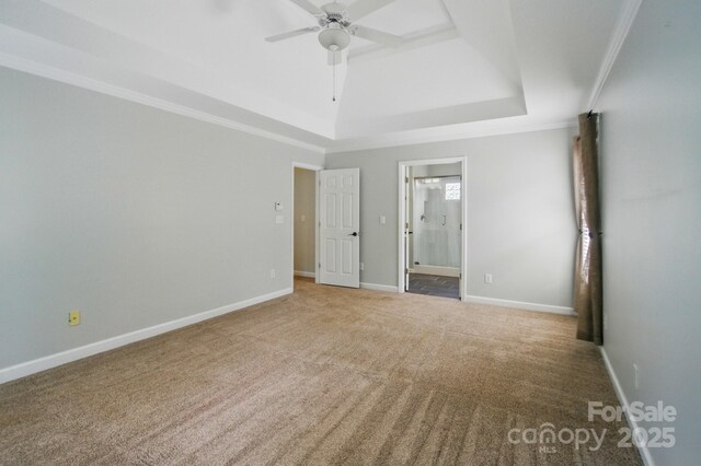 138 Montibello Dr, Mooresville, NC 28117 - unfurnished bedroom featuring a tray ceiling, carpet floors, ensuite bathroom, baseboards, and crown molding