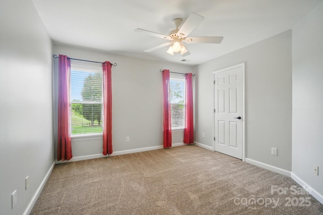 138 Montibello Dr, Mooresville, NC 28117 - unfurnished bedroom with multiple windows, carpet floors, baseboards, and a ceiling fan