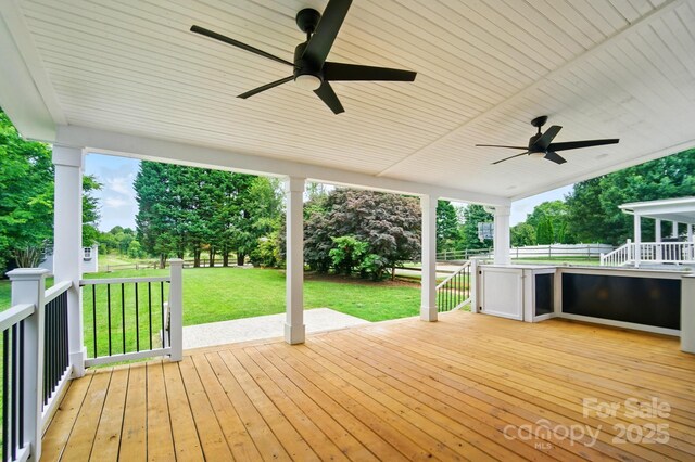 138 Montibello Dr, Mooresville, NC 28117 - wooden terrace with a ceiling fan, a yard, and view of wooded area