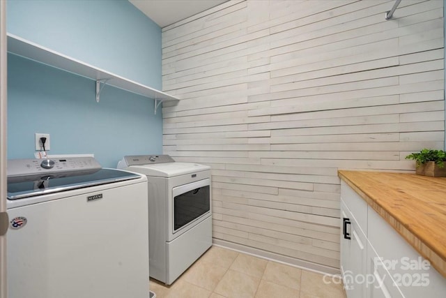 9530 Hightower Oak St, Huntersville, NC 28078 - washroom with independent washer and dryer, wooden walls, light tile patterned floors, and cabinet space