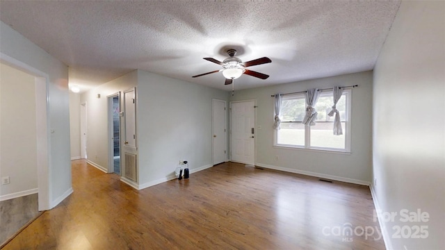 2026 Willow Ridge St, Conover, NC 28613 - spare room featuring ceiling fan, wood finished floors, a textured ceiling, and baseboards