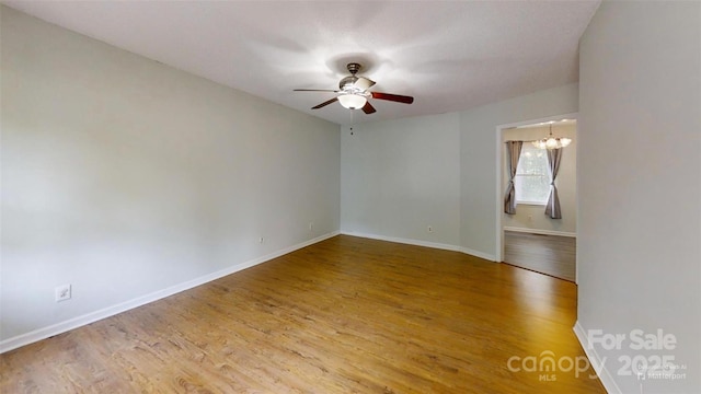 2026 Willow Ridge St, Conover, NC 28613 - spare room featuring a ceiling fan, wood finished floors, baseboards, and a chandelier