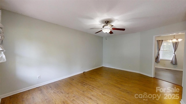 2026 Willow Ridge St, Conover, NC 28613 - spare room with a ceiling fan, wood finished floors, baseboards, and a chandelier
