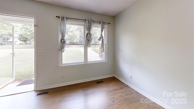 2026 Willow Ridge St, Conover, NC 28613 - unfurnished room with wood finished floors, baseboards, and plenty of natural light