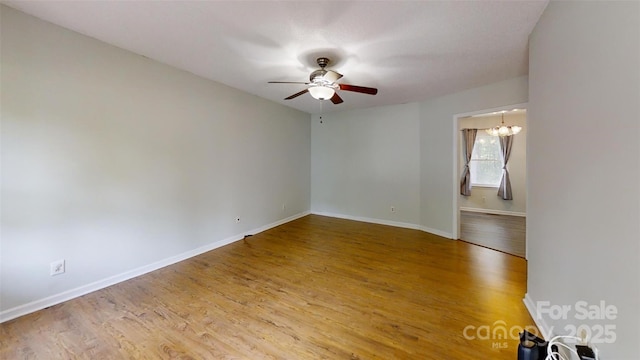 2026 Willow Ridge St, Conover, NC 28613 - spare room featuring a ceiling fan, wood finished floors, baseboards, and a chandelier