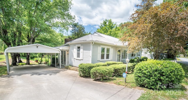 1463 Land St, Lenoir, NC 28645 - view of front of home with a detached carport, concrete driveway, metal roof, and a standing seam roof