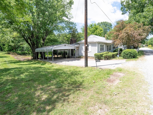 1463 Land St, Lenoir, NC 28645 - view of grassy yard featuring a detached carport and concrete driveway