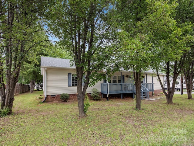 back of house with crawl space, covered porch, and a shingled roof