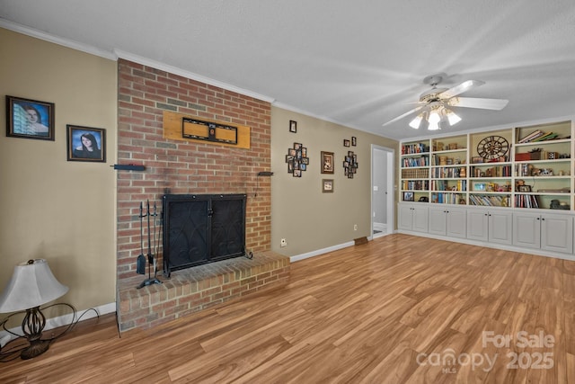 unfurnished living room featuring wood finished floors, ornamental molding, baseboards, a brick fireplace, and a textured ceiling