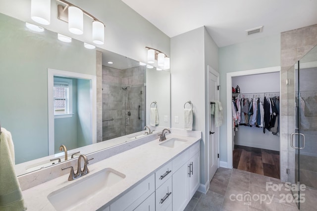 122A Deer Brook Dr Unit A, Shelby, NC 28150 - bathroom featuring a stall shower, double vanity, a spacious closet, baseboards, and tile patterned floors