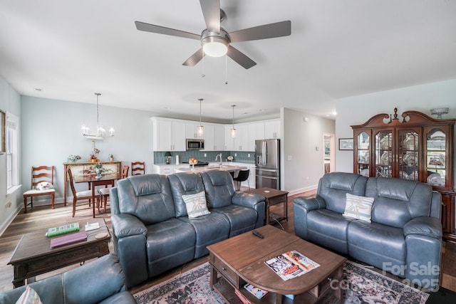 122A Deer Brook Dr Unit A, Shelby, NC 28150 - living room with baseboards, wood finished floors, a ceiling fan, and a chandelier