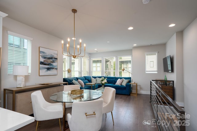 dining area with recessed lighting, hardwood / wood-style floors, a chandelier, and baseboards