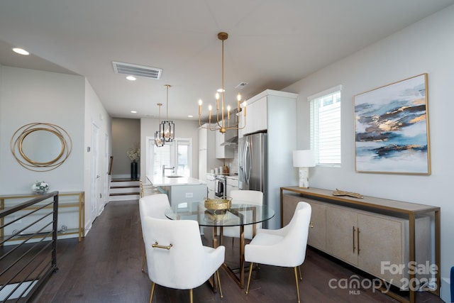 dining room featuring a chandelier, dark wood-style floors, and recessed lighting