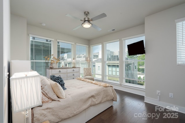 bedroom featuring baseboards, wood finished floors, and a ceiling fan