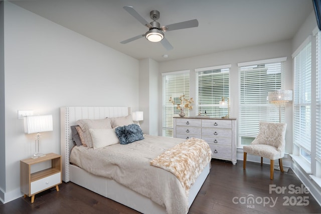 bedroom featuring dark wood finished floors, baseboards, and ceiling fan