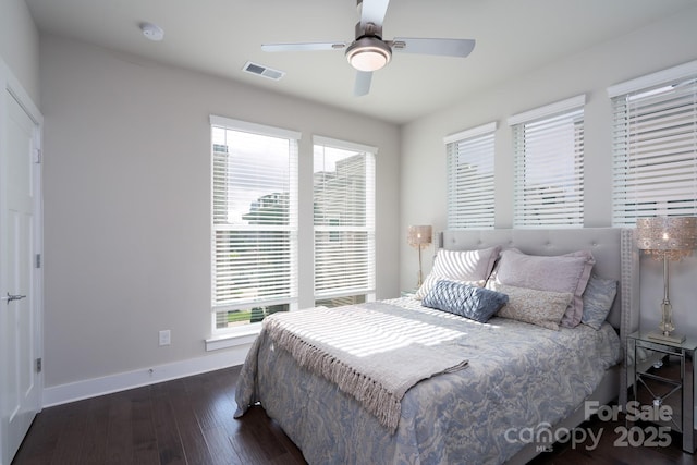 bedroom featuring baseboards, hardwood / wood-style floors, and ceiling fan