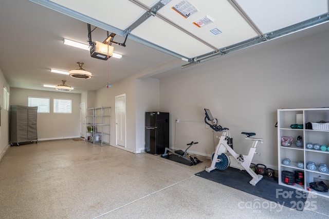 garage featuring a garage door opener and baseboards
