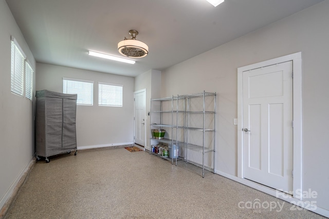 spare room with baseboards