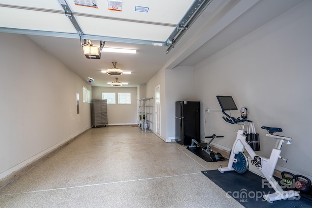 garage featuring a garage door opener and baseboards