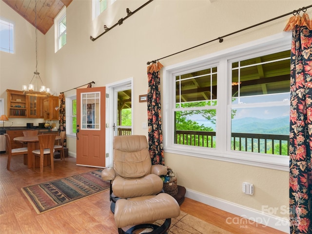 572 Multiflora Way, Waynesville, NC 28785 - sitting room with light wood finished floors, baseboards, a chandelier, high vaulted ceiling, and wooden ceiling