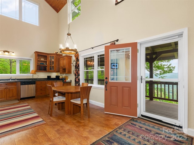 572 Multiflora Way, Waynesville, NC 28785 - dining room with light wood-style floors, a chandelier, baseboards, and high vaulted ceiling