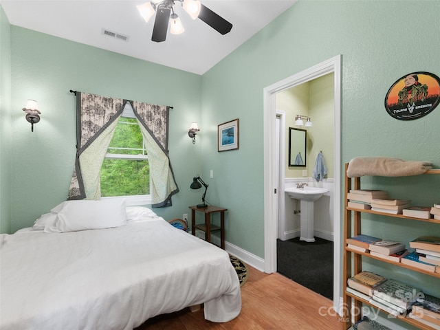 572 Multiflora Way, Waynesville, NC 28785 - bedroom featuring connected bathroom, wood finished floors, a ceiling fan, and baseboards