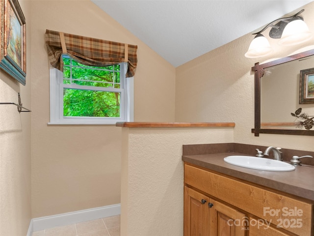 572 Multiflora Way, Waynesville, NC 28785 - bathroom with lofted ceiling, vanity, baseboards, and tile patterned floors