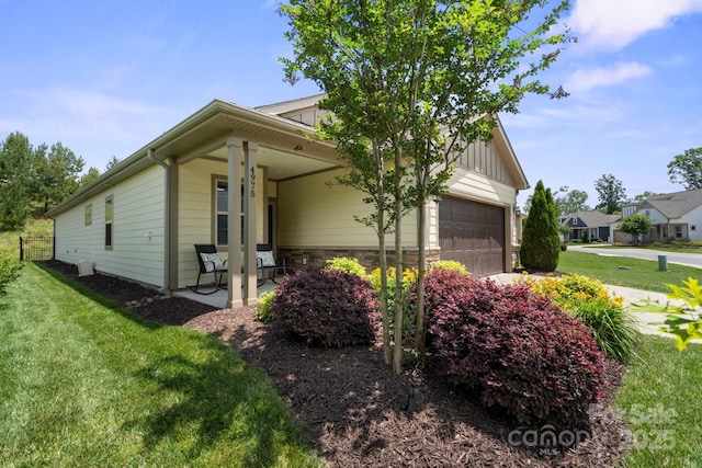 4975 Looking Glass Trl, Denver, NC 28037 - view of front of property featuring a front lawn, stone siding, an attached garage, and driveway