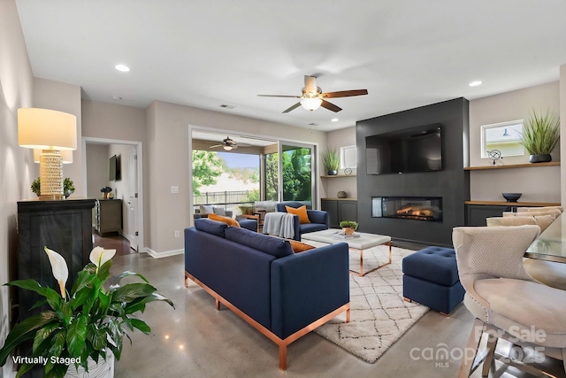 4975 Looking Glass Trl, Denver, NC 28037 - living area with concrete floors, a large fireplace, a ceiling fan, baseboards, and recessed lighting
