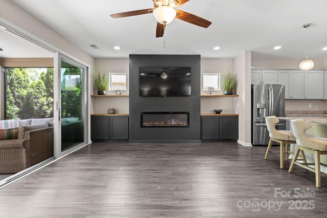 4975 Looking Glass Trl, Denver, NC 28037 - living room with dark wood finished floors, a ceiling fan, a fireplace, and recessed lighting