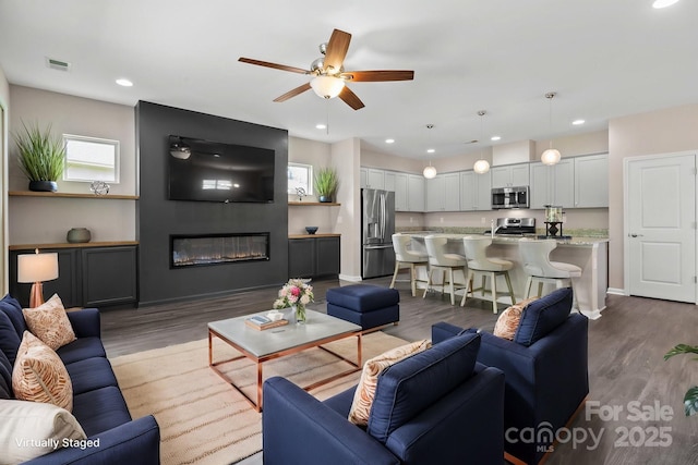 4975 Looking Glass Trl, Denver, NC 28037 - living area with ceiling fan, dark wood finished floors, a fireplace, recessed lighting, and baseboards