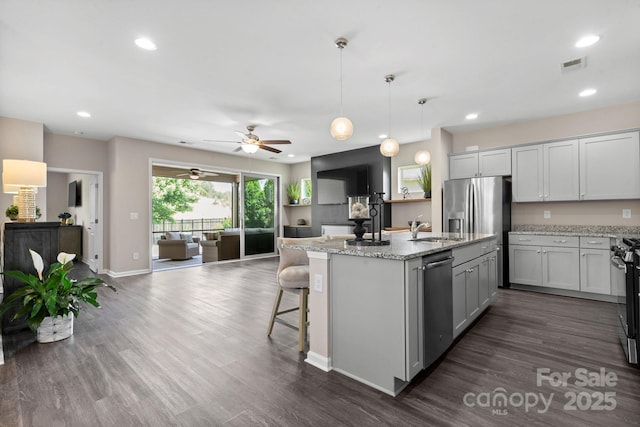 4975 Looking Glass Trl, Denver, NC 28037 - kitchen with open floor plan, appliances with stainless steel finishes, a sink, an island with sink, and dark wood-style floors