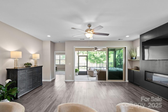 4975 Looking Glass Trl, Denver, NC 28037 - living area with wood finished floors, ceiling fan, baseboards, recessed lighting, and a glass covered fireplace