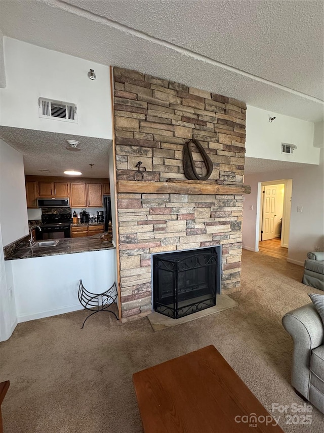 303 Sugar Top Dr Unit 2323, Sugar Mountain, NC 28604 - carpeted living room with a textured ceiling, a fireplace, and a sink
