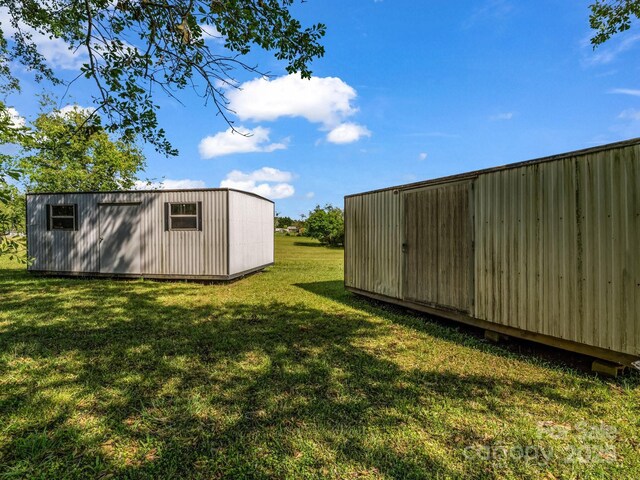 646 Terry Rd, Ellenboro, NC 28040 - view of green lawn featuring an outdoor structure and a shed