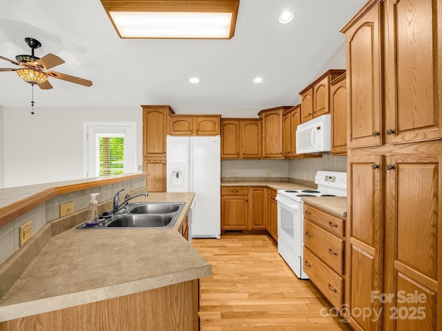 646 Terry Rd, Ellenboro, NC 28040 - kitchen featuring white appliances, a sink, a ceiling fan, light wood finished floors, and decorative backsplash